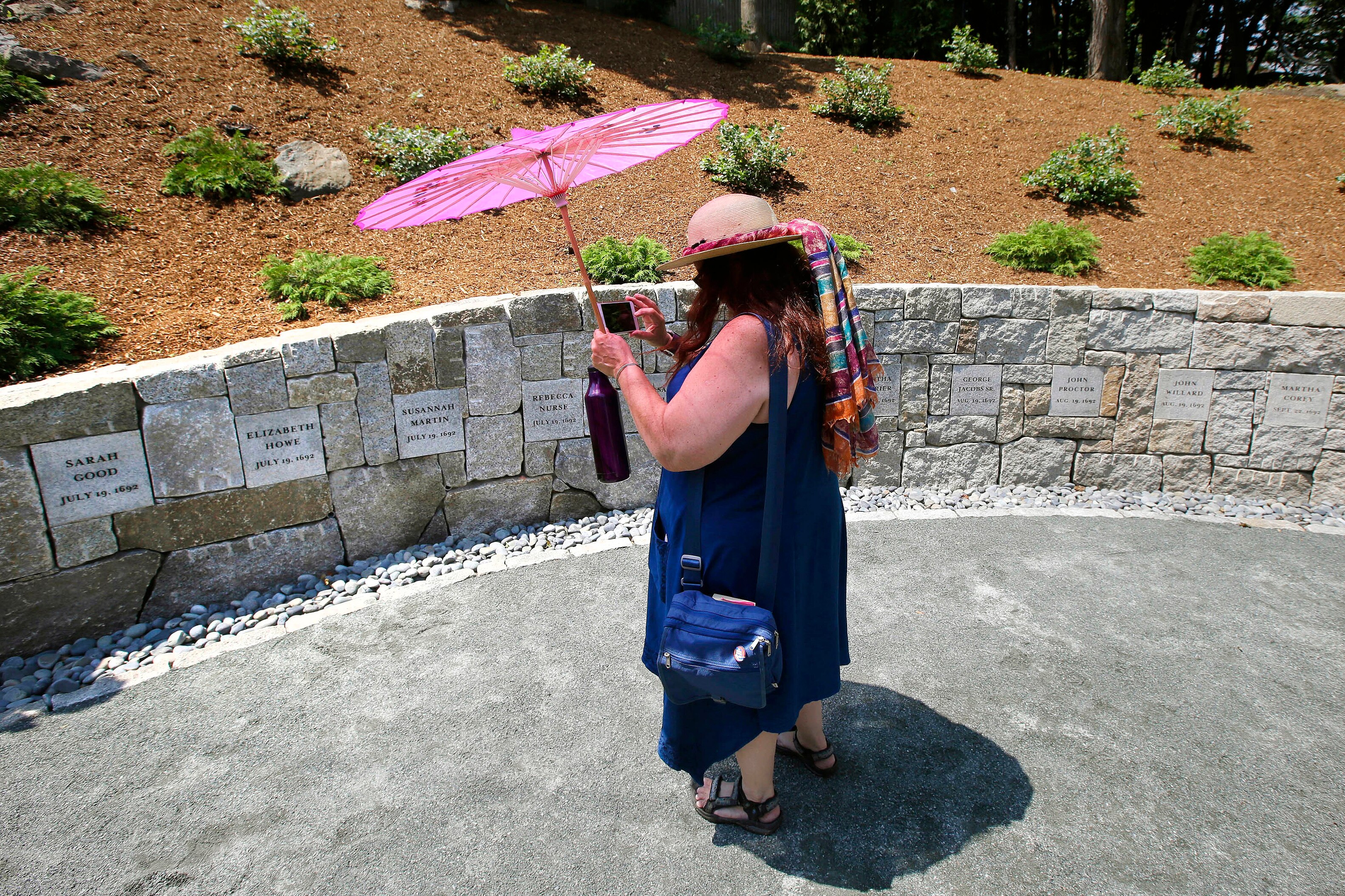 A teacher standing in front of a memorial site in Salem, Massachusetts 