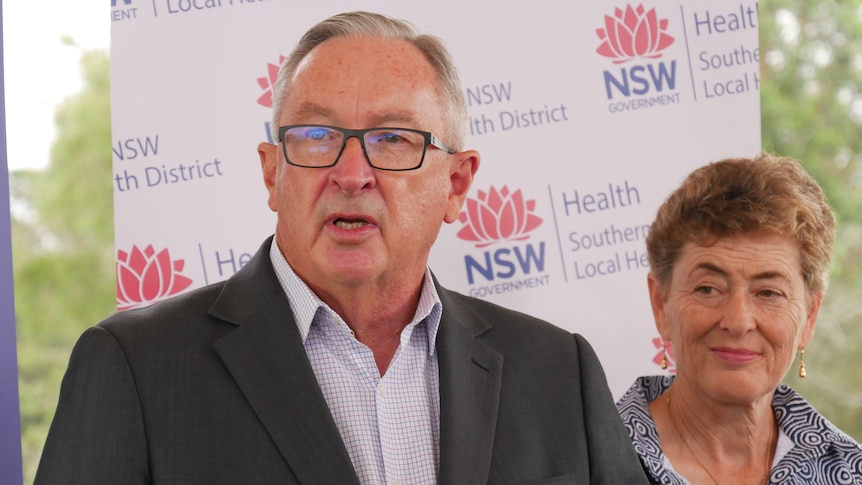 Brad Hazzard speaking with Bega candidate Fiona Kotvojs in the background.