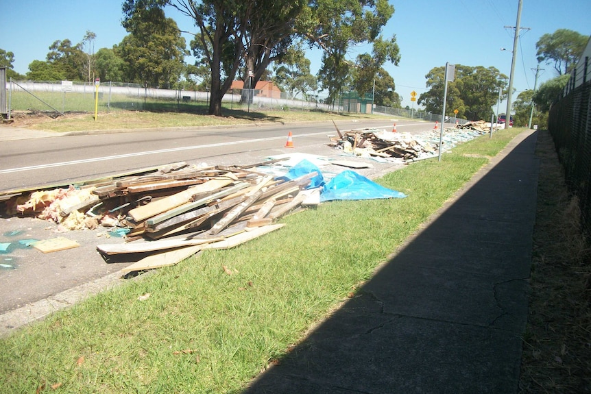 Building materials lie strewn across Boundary Road at Chester Hill.