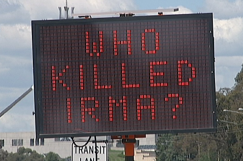 Traffic signs saying who killed Irma? in regard to unsolved bashing murder of Irma Palasics in 1999.