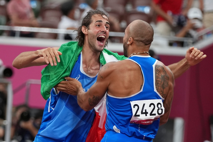 Italy's Gianmarco Tamberi (left) hugs countryman Lamont Marcell Jacobs after they won high jump and 100m gold.