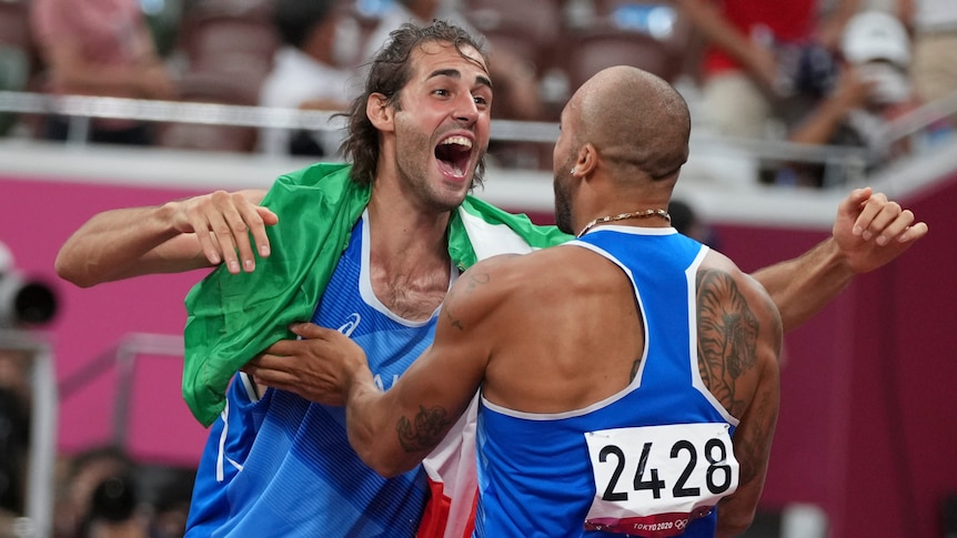 Italy's Gianmarco Tamberi (left) hugs countryman Lamont Marcell Jacobs after they won high jump and 100m gold.