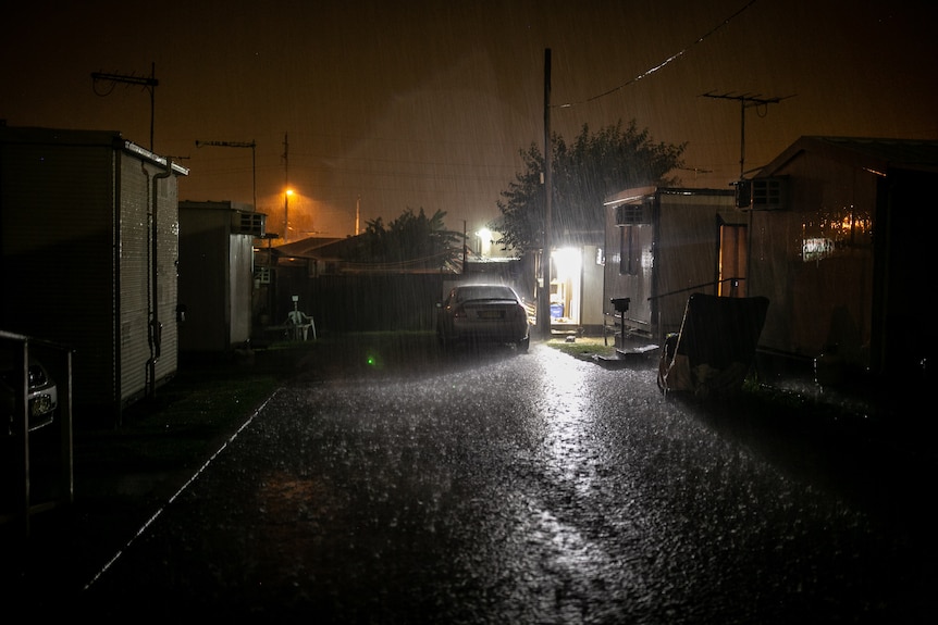 Rain pours down in the Fairfield West caravan park.