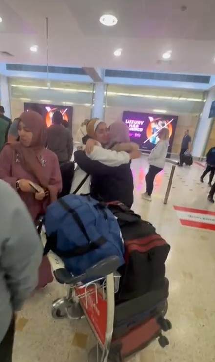 Jo Jo embraces her aunty at Sydney airport after a long flight. 