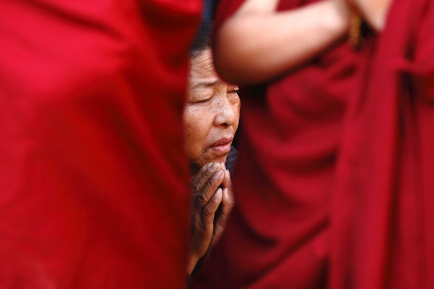 Tibetan woman prays in Kathmandu