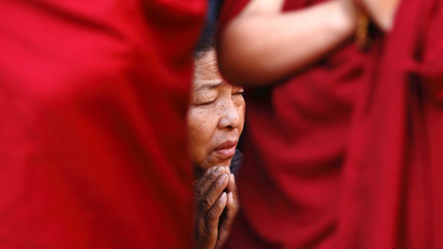 Tibetan woman prays in Kathmandu