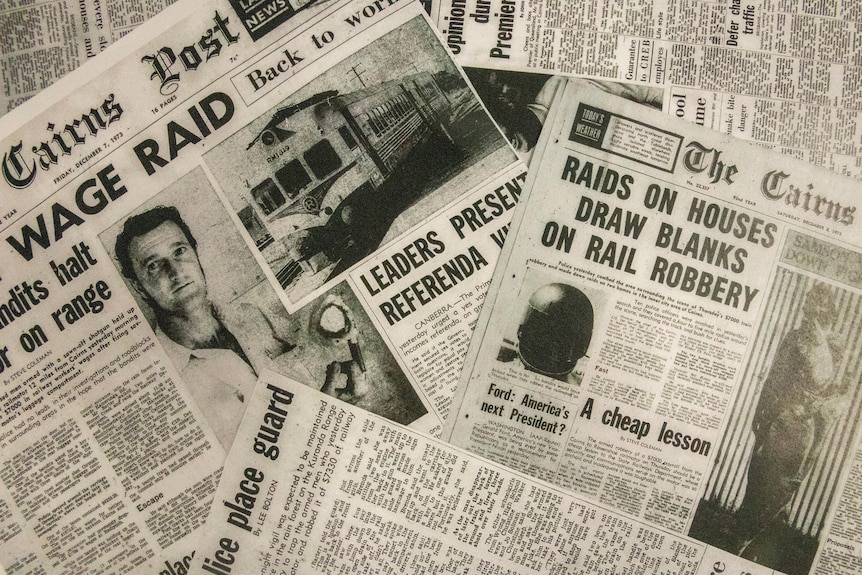 An assortment of newspaper articles with headlines and photographs about the robbery of a train