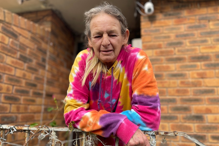 Dianne Marcus standing outside her home