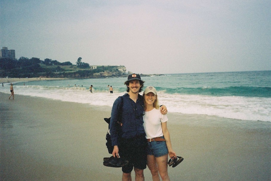 A photo of a man and a woman at a beach