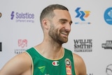 A basketball player speaks to media off camera.