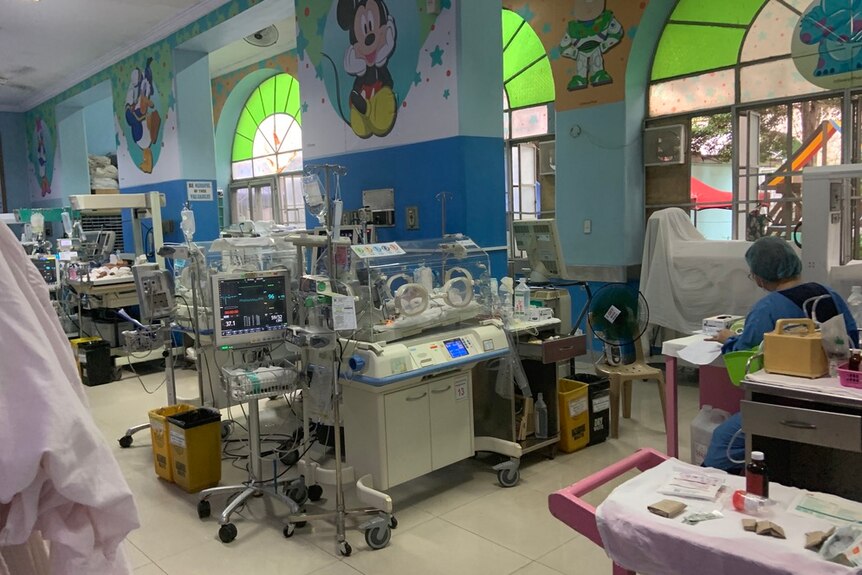 A brightly coloured hospital room for children in the Philippines, with intensive care pods