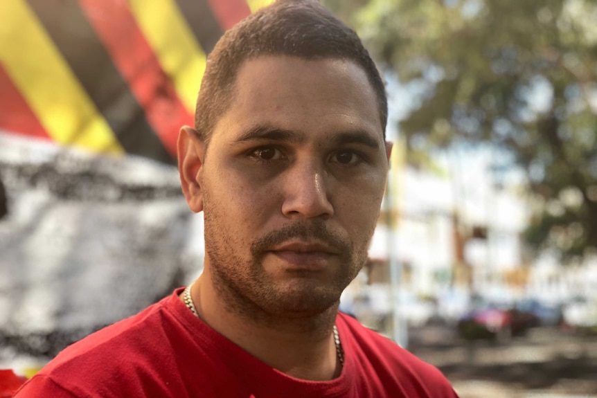 Close-up headshot of Keenan Mundine who is wearing a red shirt.