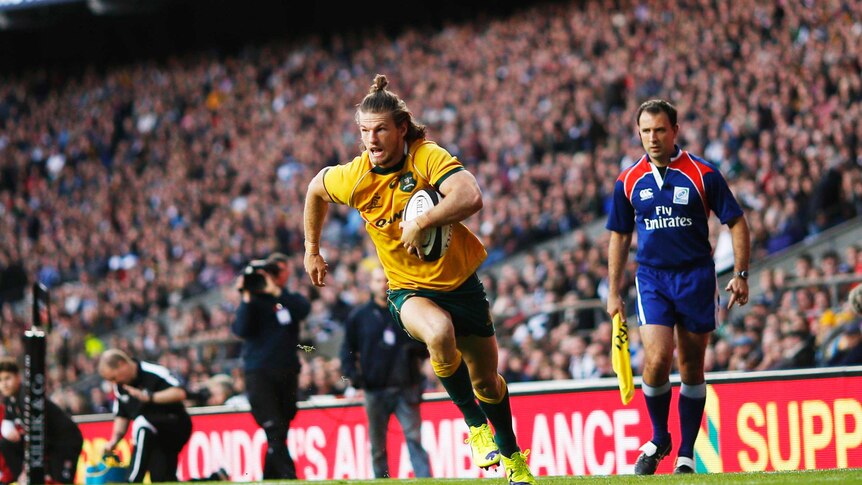 Rob Horne of Australia runs in to score a try during a rugby union match between Barbarians and the Wallabies at Twickenham
