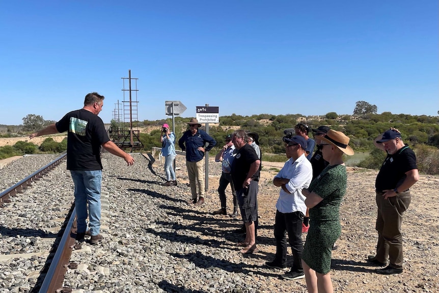 State upper house politicians being shown around outside Menindee by locals.