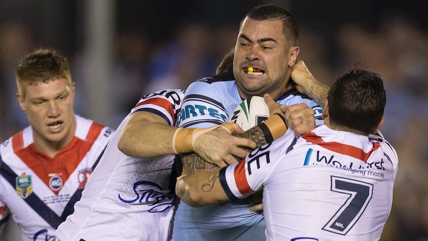 Andrew Fifita of the Sharks is tackled by Mitchell Pearce of the Roosters at Shark Park.