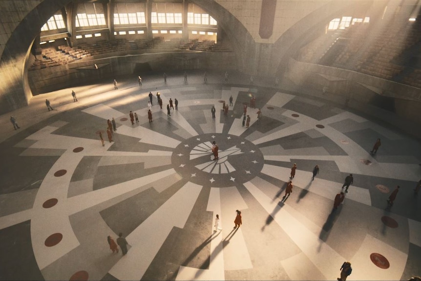 A grand indoor arena, dressed for The Hunger Games film.