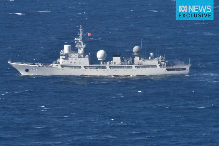 A large ship flying China's flag sits on open waters.