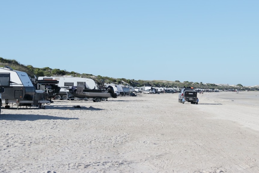 White sandy beach. sand dunes, cars, caravans, trailers, driving.