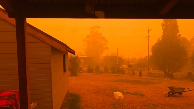 Red bushfire smoke over suburban home in Cobargo, NSW