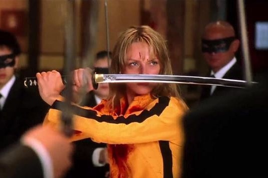 A scene from the movie Kill Bill where Uma Thurman holds a sword.