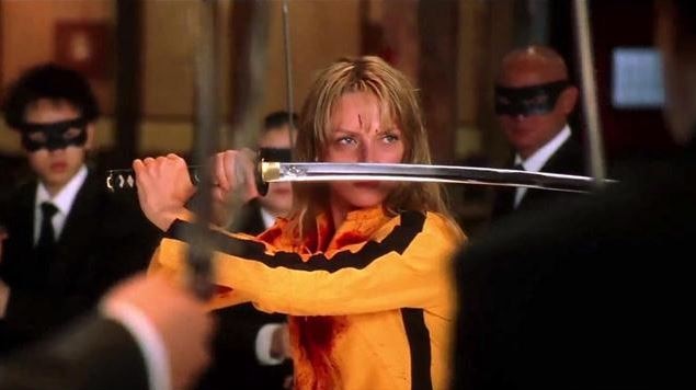 A scene from the movie Kill Bill where Uma Thurman holds a sword.