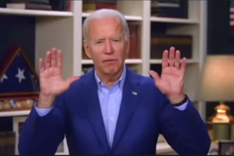 Joe Biden holds his hands up, showing his palms