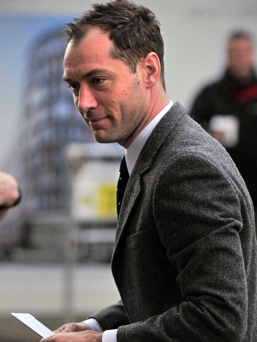 Jude Law arrives at London court for phone backing trial