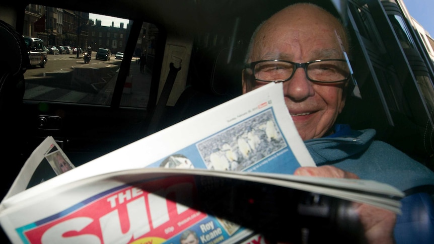 Rupert Murdoch reads The Sun newspaper