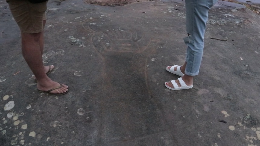 Incorrectly re-engraved rock markings are shown with a human figure.