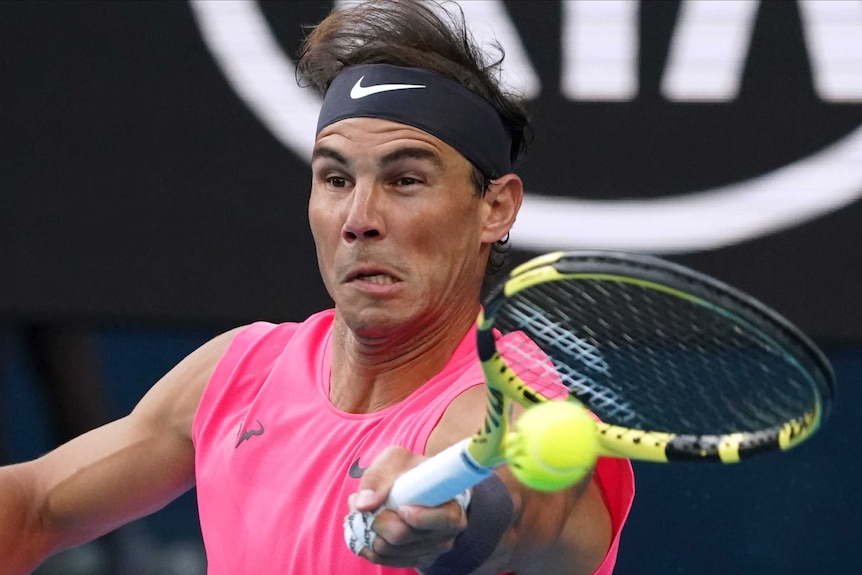 A male tennis plays a forehand at the Australian Open.