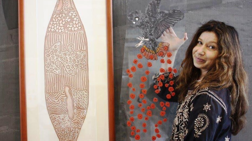 Textile artist Dr Treahna Hamm stands with her artwork.