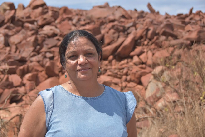 woman standing in front of rocks