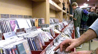 Customers in a central Melbourne music store look through compact discs.