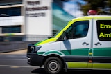 An ambulance driving past the Royal Adelaide Hospital
