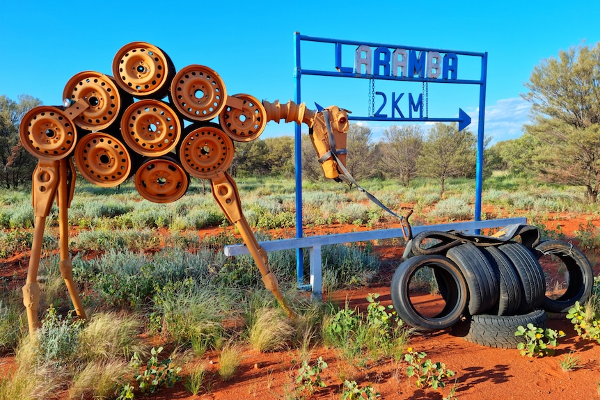 A sign pointing to the remote community of Laramba with 2km next to it.