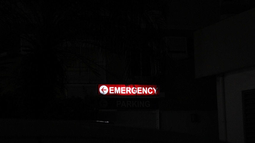 An emergency department sign surrounded by darkness