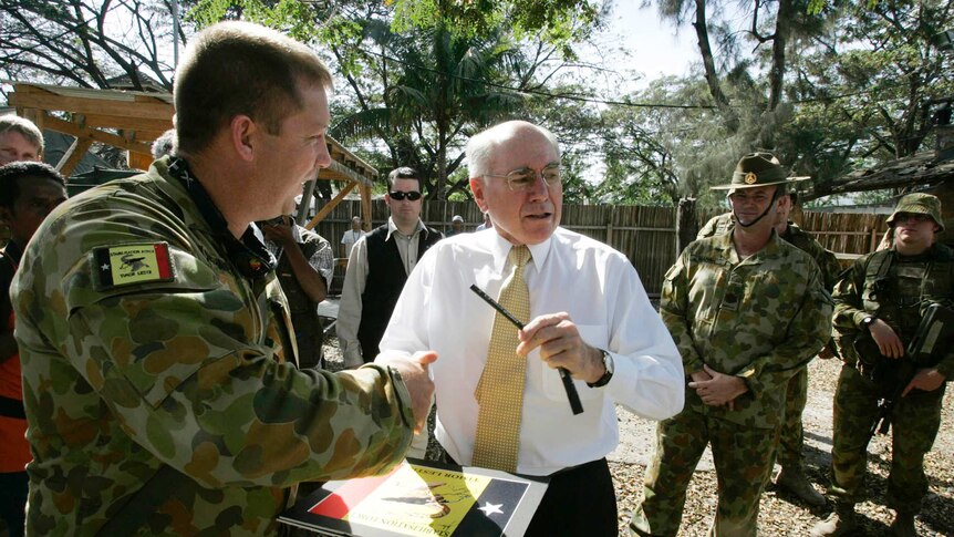 John Howard shakes hands with an Australian troop in Dili