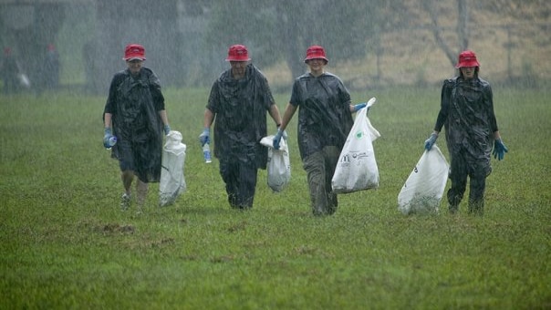 People pick up rubbish in a park