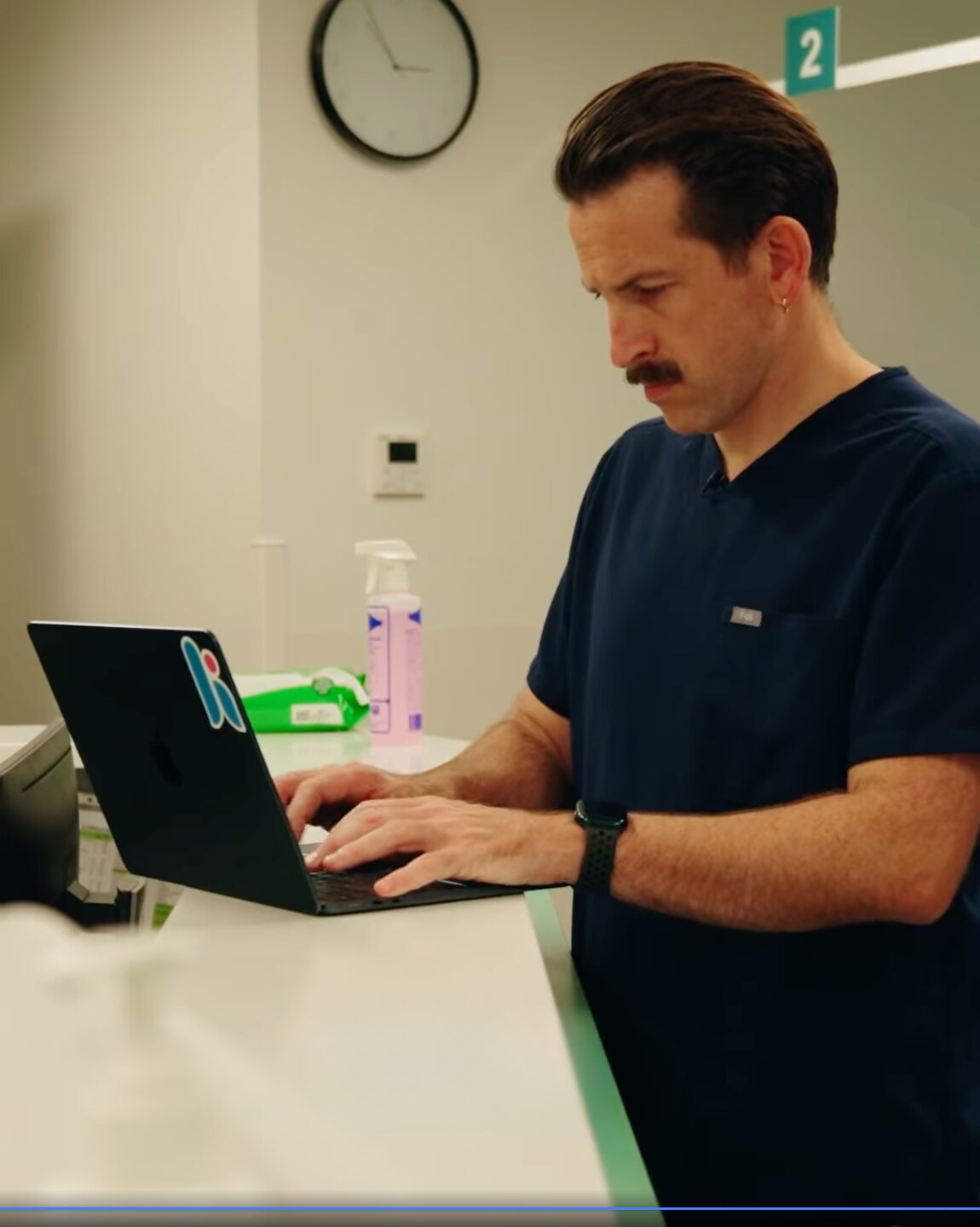 A man is working on a laptop in his office