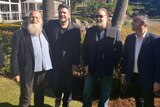Russell Crowe stands with a group of men