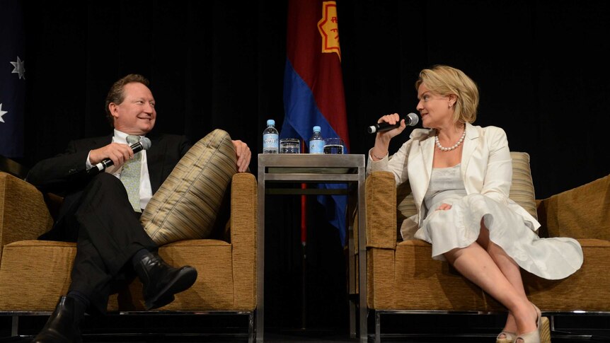 Andrew and Nicola Forrest sit on armchairs with microphones.