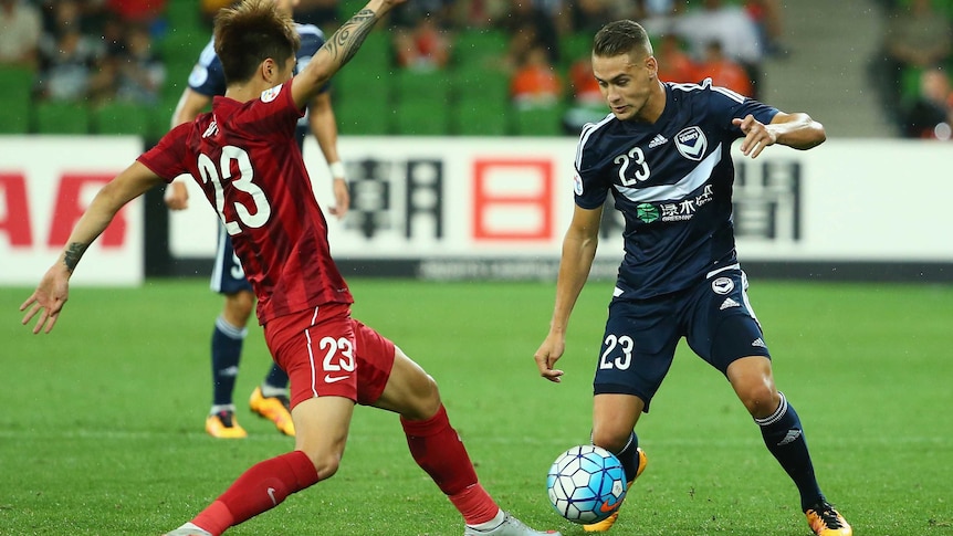 Huan Fu of Shanghai SIPG challenges Jai Ingham of Melbourne Victory during the AFC Asian Champions League.