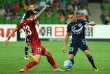 Huan Fu of Shanghai SIPG challenges Jai Ingham of Melbourne Victory during the AFC Asian Champions League.