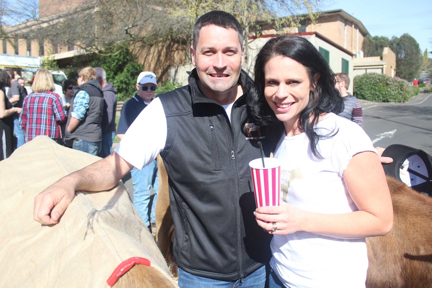 Steve Ronalds and Sallie Jones at stand with two Jersey cows.