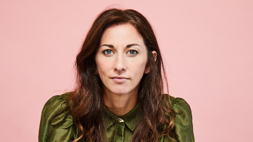 Portrait of radio and podcast presenter and comedian Veronica Milson against a pink background.