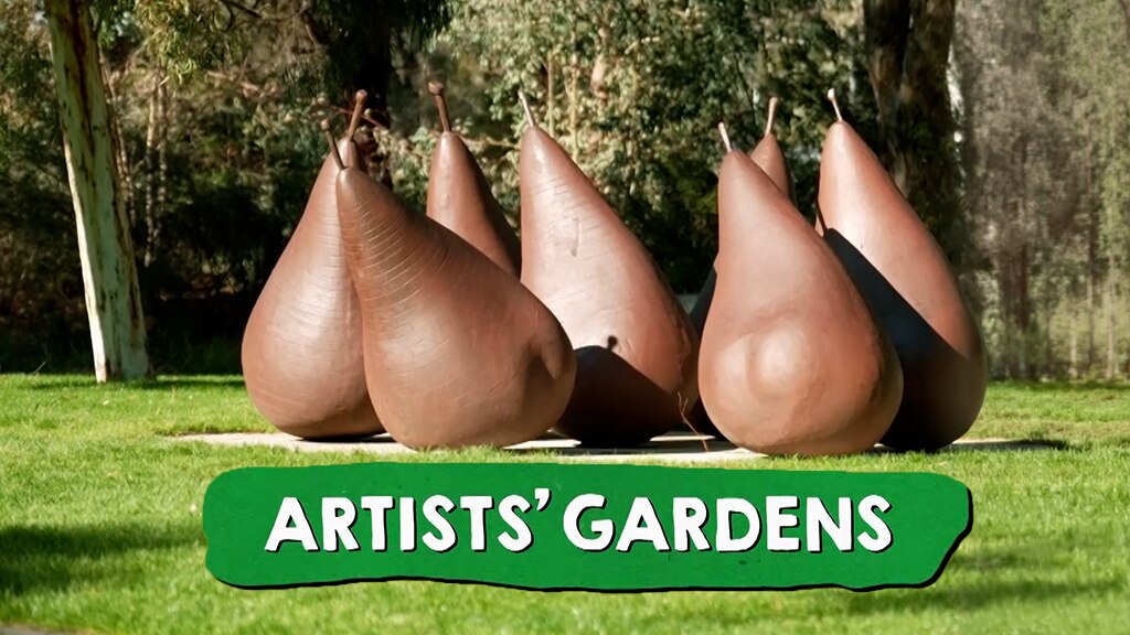 Large pear sculptures on a lawn.