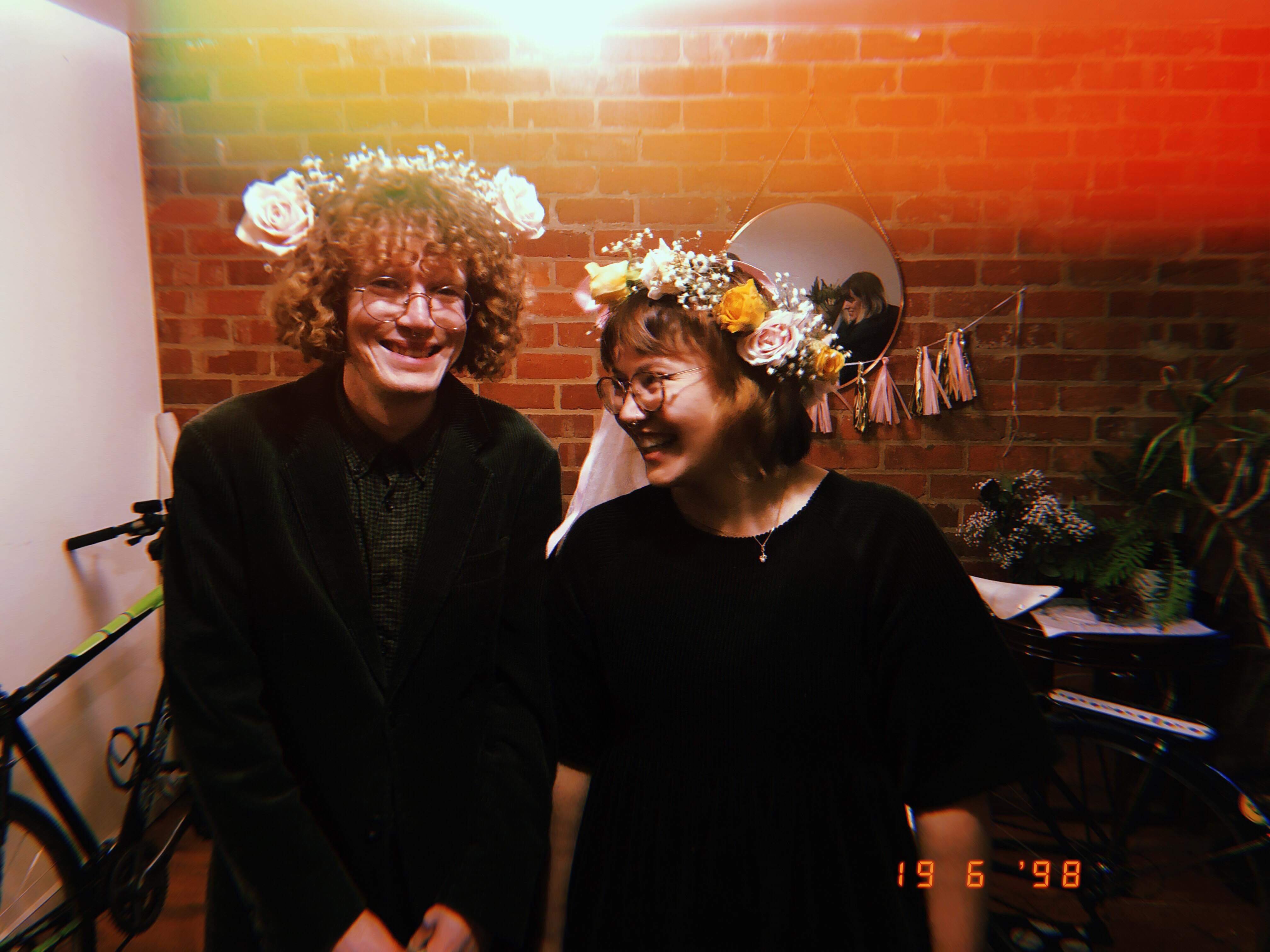 Sian and Murray in their house wearing home-made flower crowns.