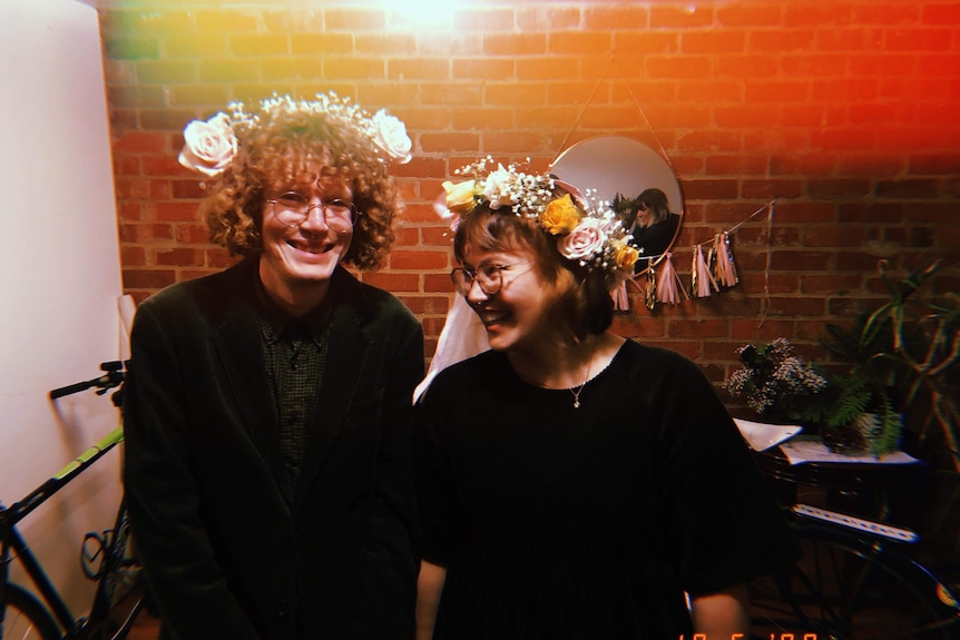 Sian and Murray in their house wearing home-made flower crowns.
