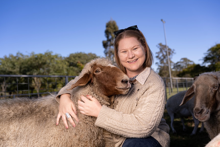 A woman hugs a sheep