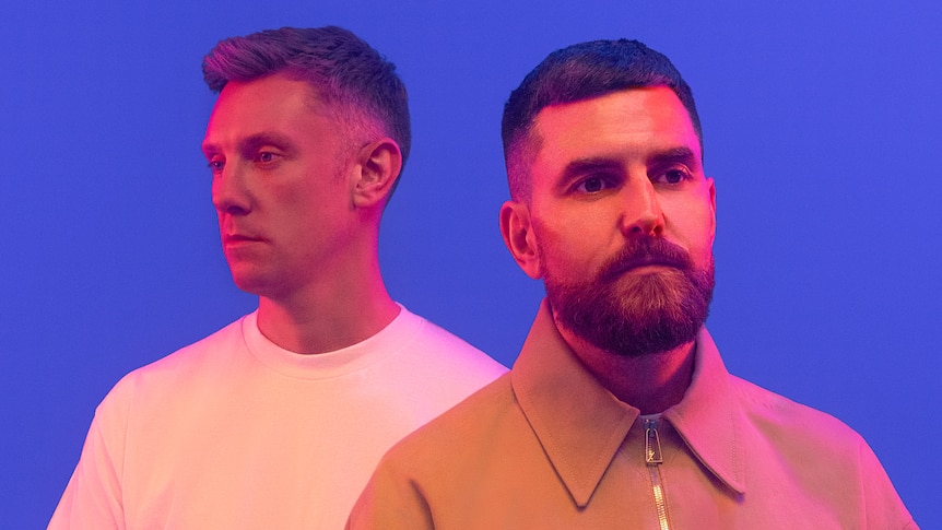 Two members of Irish electro duo Bicep staring into the distance before a purple background.